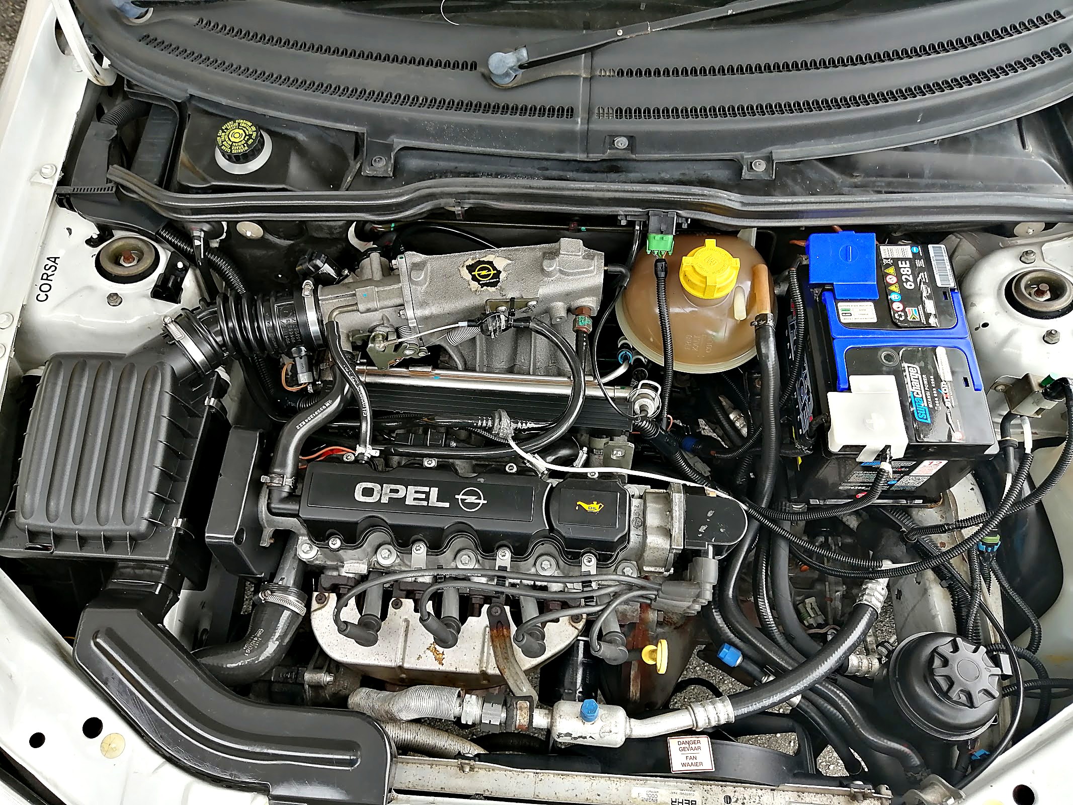 Engine bay of a car being serviced at Anton's Auto Centre